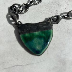 Black and green artisan style chunky necklace with a unique heart design